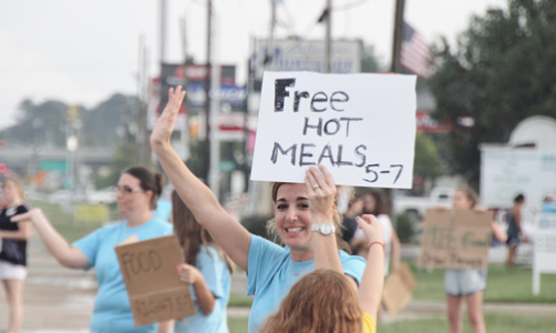 photo of Employee donating hot meals to flood victims 